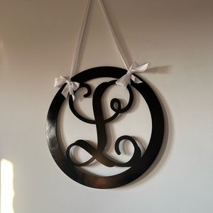 Hanging wooden L. Cursive